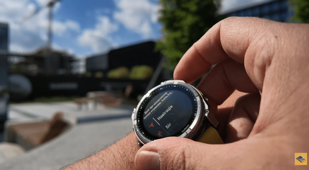 Garmin Fenix 8 на зап'ясті надворі з відкритим меню навігації на екрані