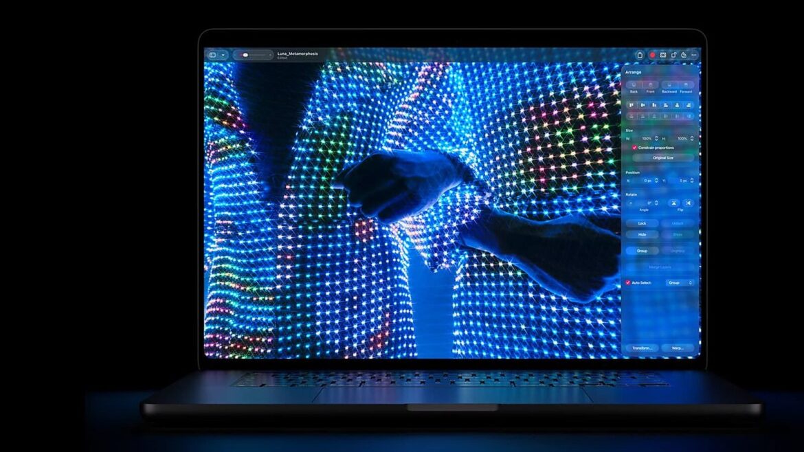 MacBook Pro з яскравим OLED-екраном, де на тлі світлодіодної сітки видно силует руки і панель інструментів програми
