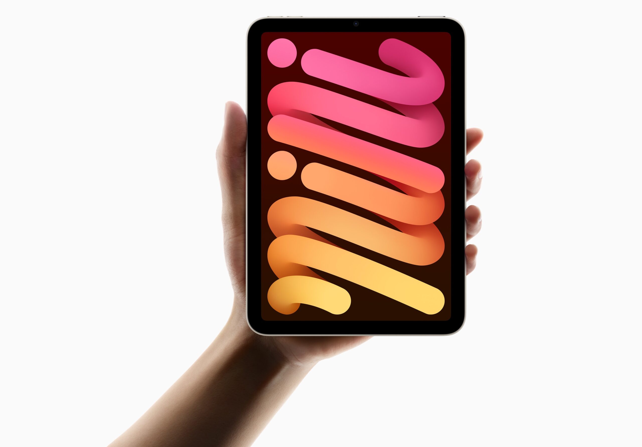 IPad mini з OLED дисплеєм у руці, на якому показано кольорові хвилясті форми від рожевого до жовтого