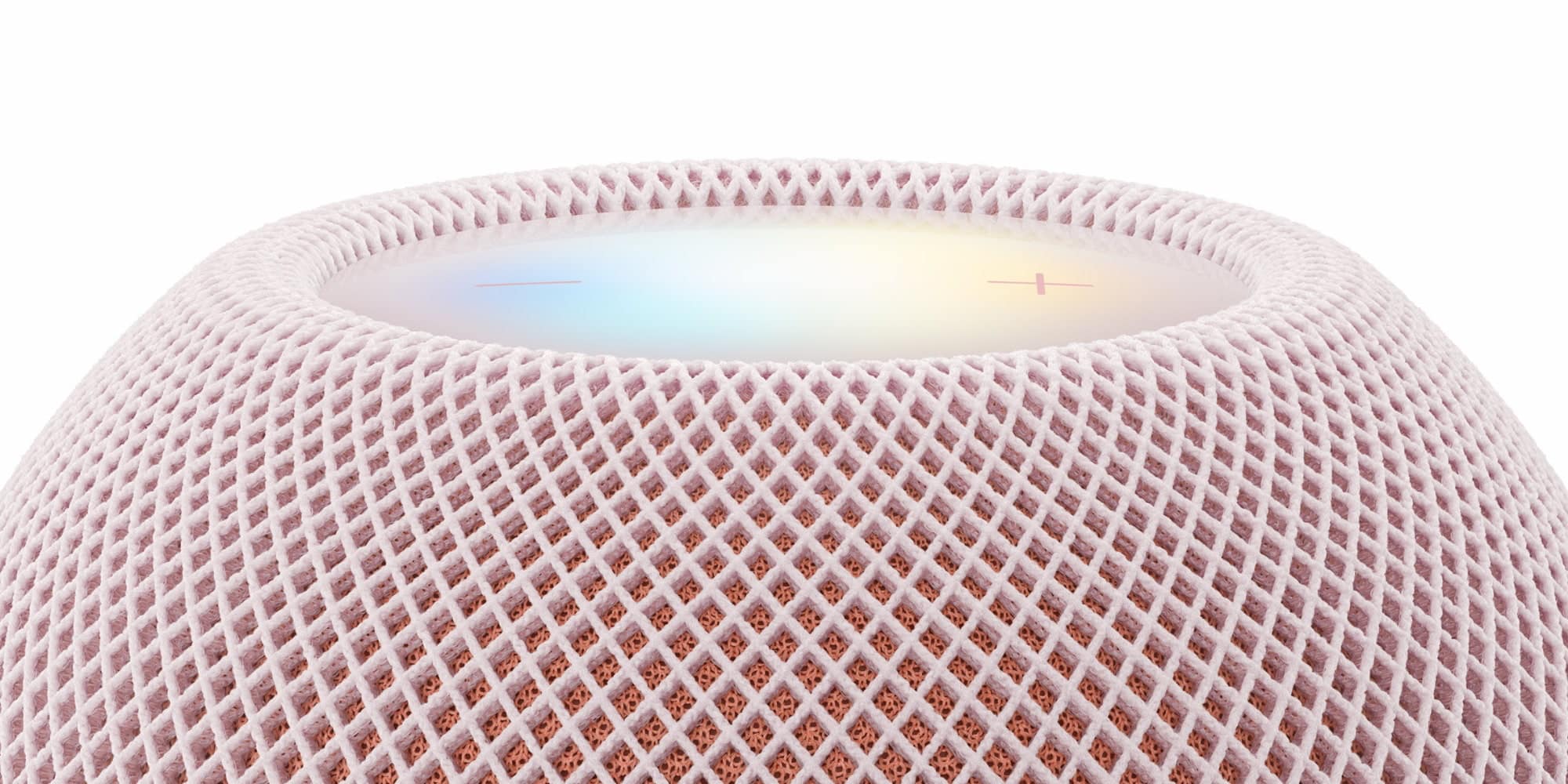 Крупний план верхньої панелі HomePod mini 2 розового кольору з сітчастою текстурою
