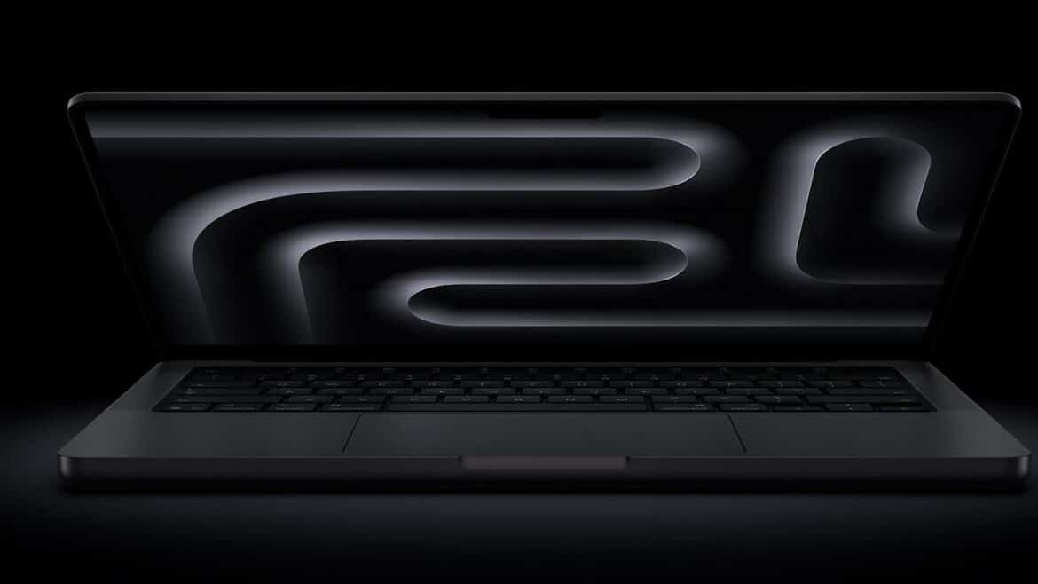 Відкритий темно-сірий MacBook Pro на чорному тлі, на екрані біло-сірі плавні абстрактні лінії