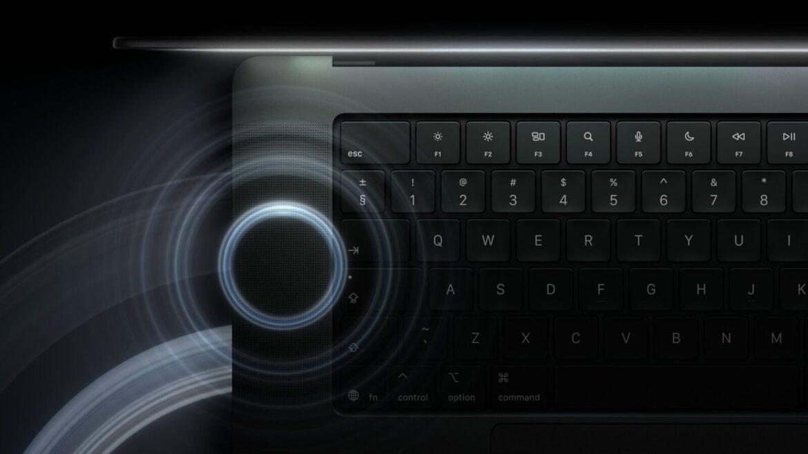Клавіатура MacBook Pro крупним планом із синіми колами звуку, що розходяться від динаміка