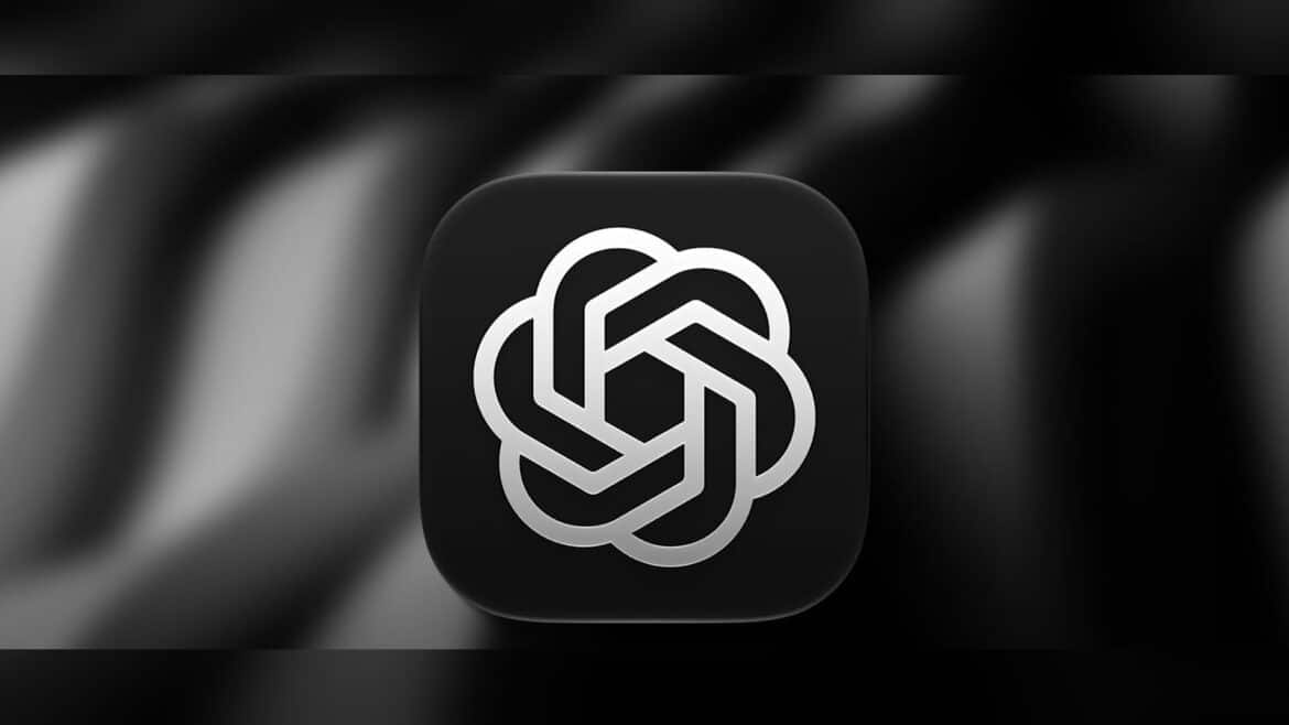 Логотип OpenAI у вигляді сріблястого переплетеного вузла на чорній заокругленій іконці на розмитому чорно-сірому тлі